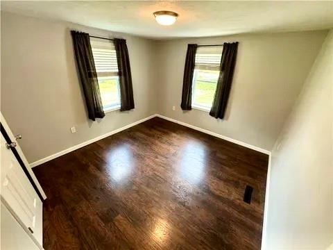 141 Shenango Road New Castle, PA 16105 - Photo 7 of 11 an empty room with wooden floor and windows