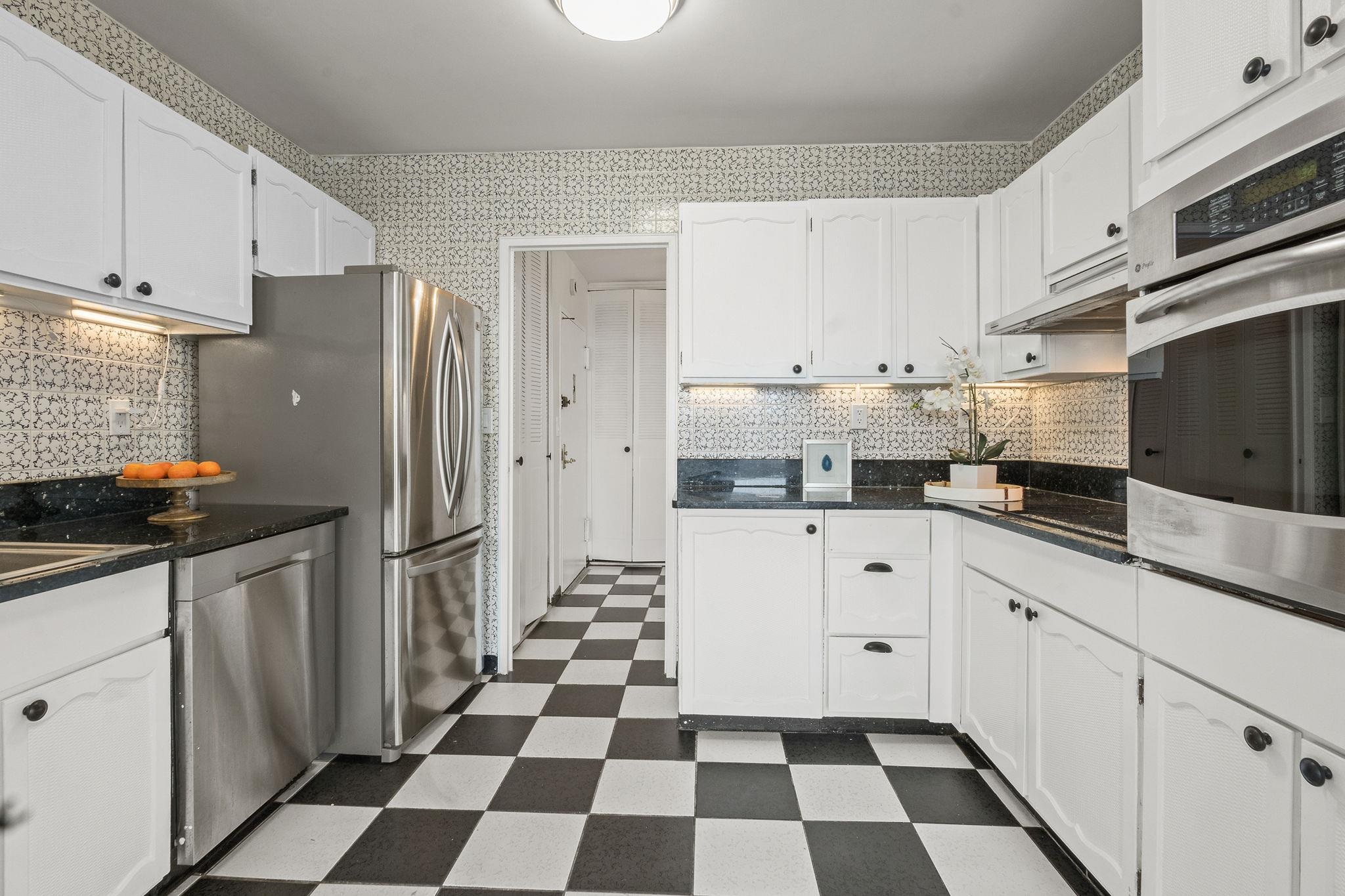 380 Mountain Road, Unit 1112 Union City, NJ 07087 - Photo 11 of 42 a kitchen with stainless steel appliances a refrigerator and cabinets