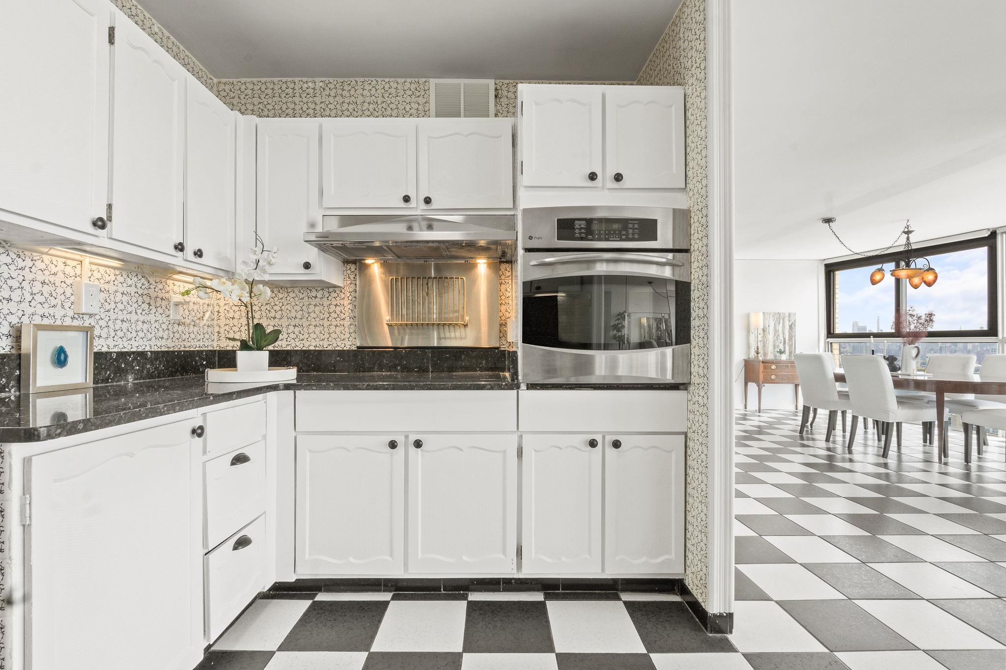 380 Mountain Road, Unit 1112 Union City, NJ 07087 - Photo 12 of 42 a kitchen with white cabinets and appliances