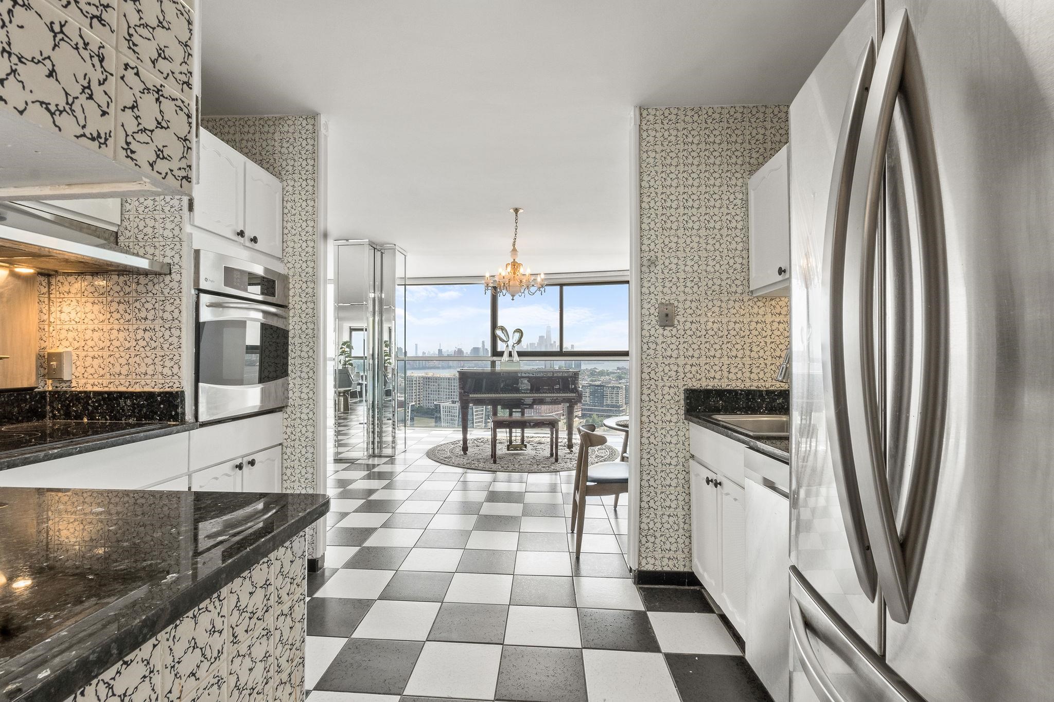 380 Mountain Road, Unit 1112 Union City, NJ 07087 - Photo 13 of 42 a kitchen with stainless steel appliances a refrigerator sink and stove