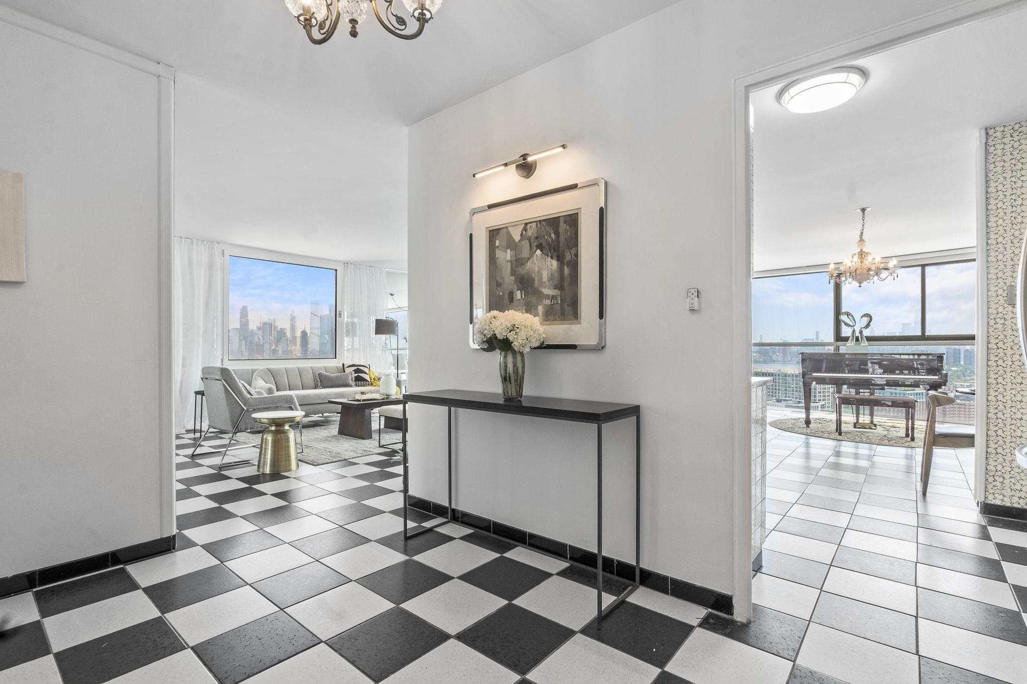 380 Mountain Road, Unit 1112 Union City, NJ 07087 - Photo 15 of 42 a kitchen with a checkered floor and white cabinets