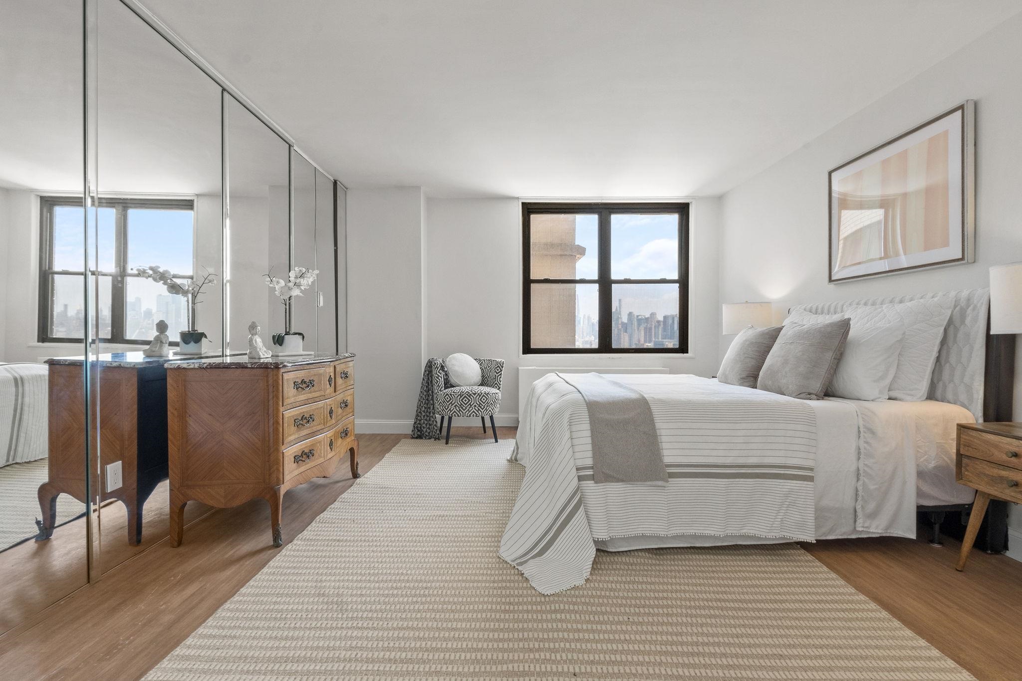 380 Mountain Road, Unit 1112 Union City, NJ 07087 - Photo 18 of 42 a bedroom with a bed and wooden floor