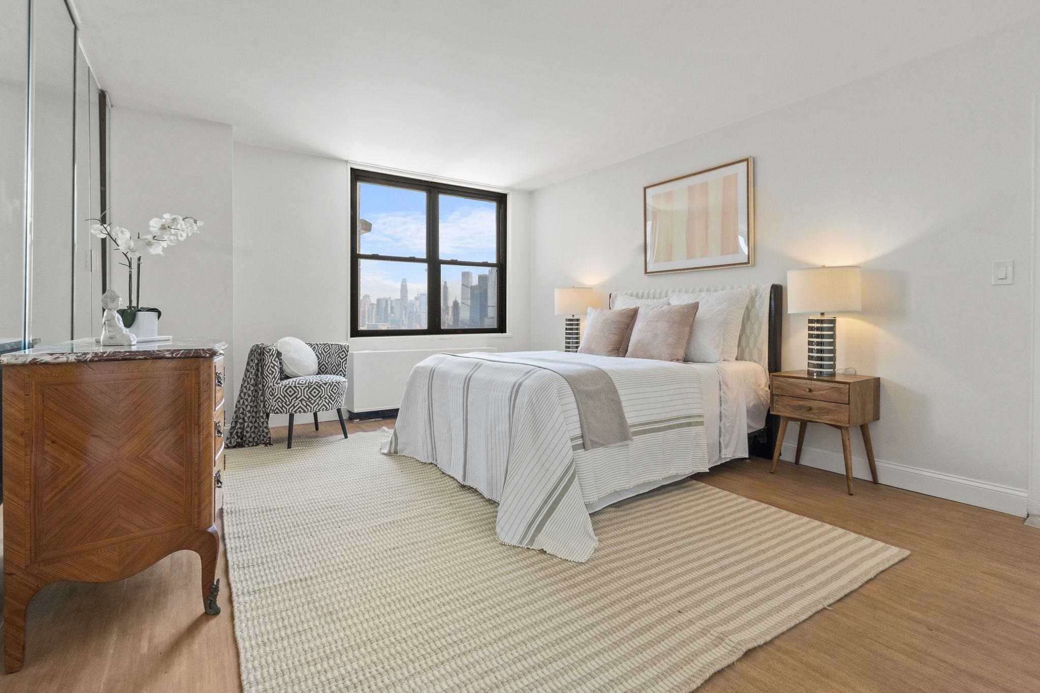 380 Mountain Road, Unit 1112 Union City, NJ 07087 - Photo 19 of 42 a bed room with a bed and a night stand