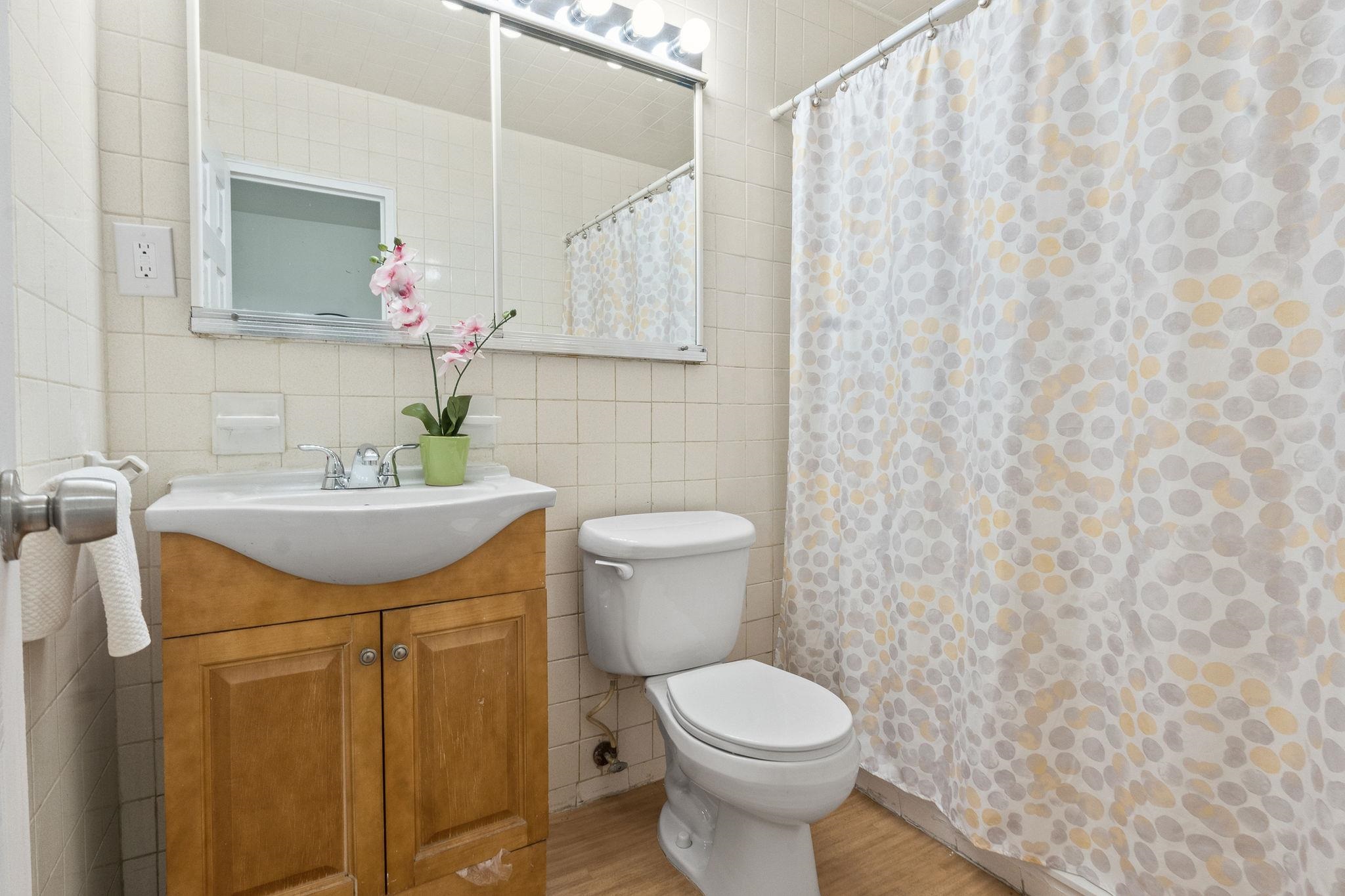 380 Mountain Road, Unit 1112 Union City, NJ 07087 - Photo 22 of 42 a bathroom with a sink a toilet and a mirror