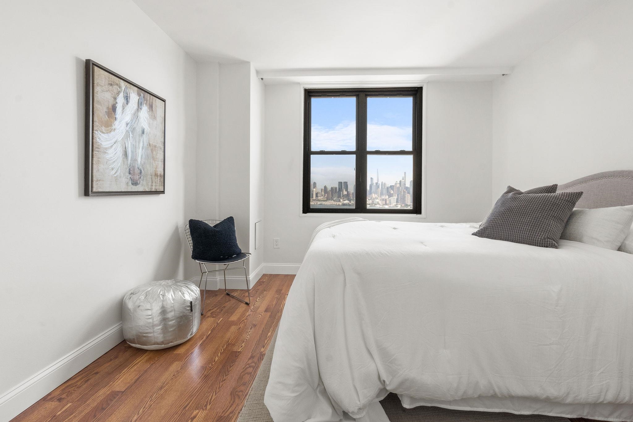 380 Mountain Road, Unit 1112 Union City, NJ 07087 - Photo 24 of 42 a bedroom with a bed and wooden floor