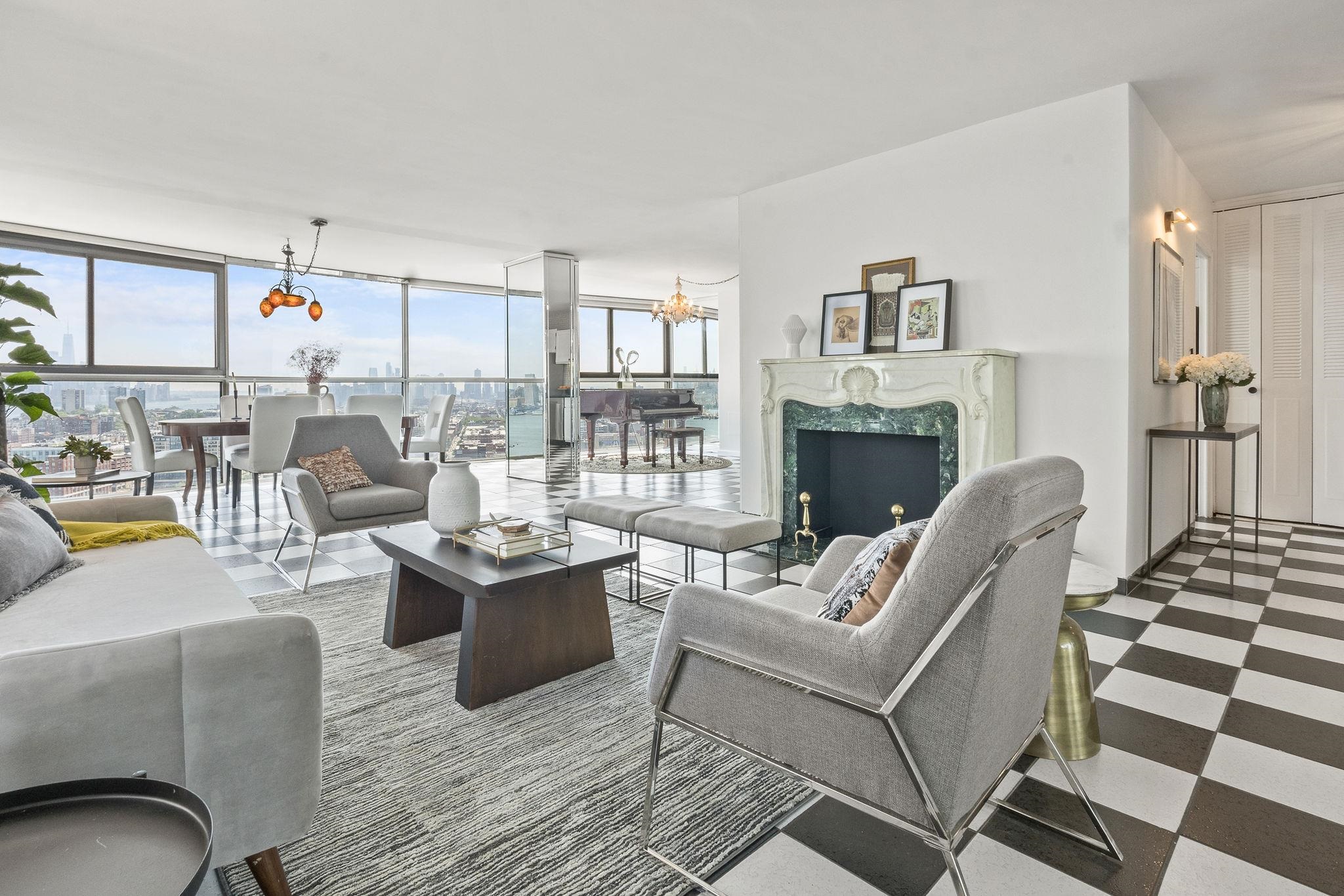 380 Mountain Road, Unit 1112 Union City, NJ 07087 - Photo 3 of 42 a living room with furniture and a fireplace