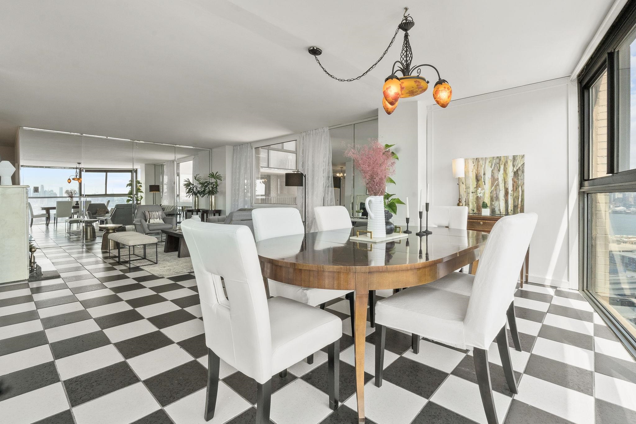 380 Mountain Road, Unit 1112 Union City, NJ 07087 - Photo 6 of 42 a view of a dining room with furniture and a chandelier