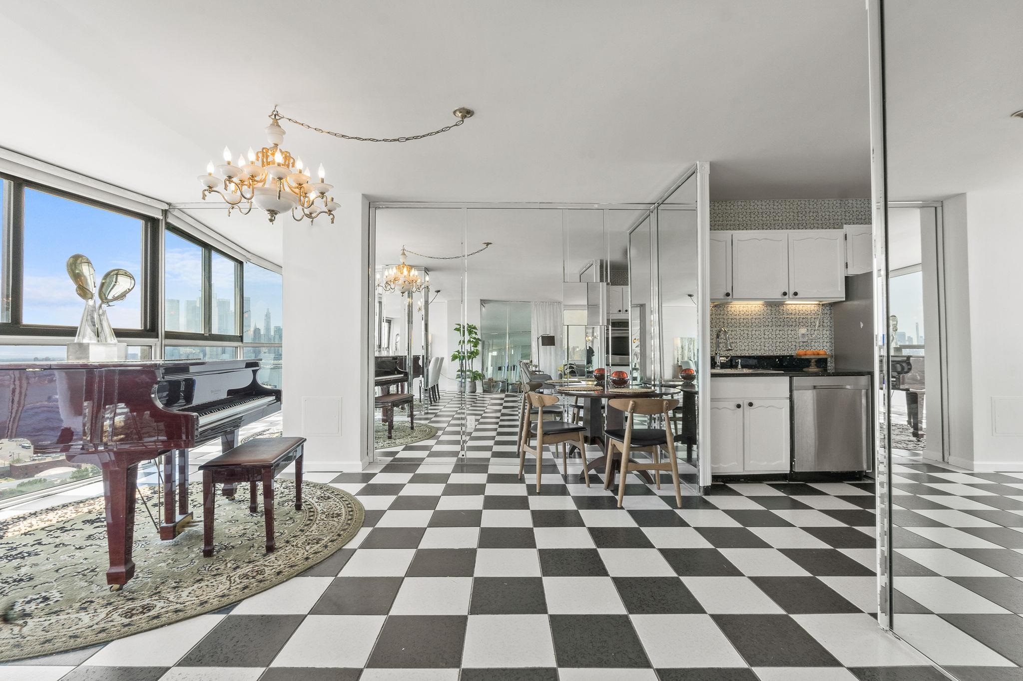380 Mountain Road, Unit 1112 Union City, NJ 07087 - Photo 10 of 42 a living room with a black white checkered floor with a dining table and chairs