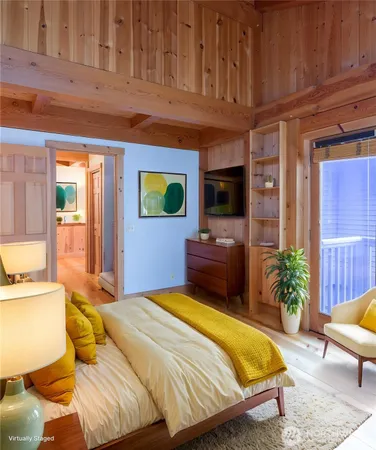 a bedroom with a bed and glass windows