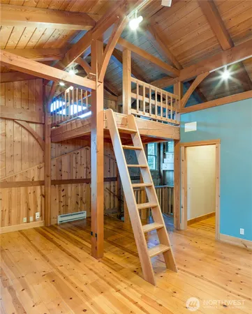 a view of wooden floor and windows in a room