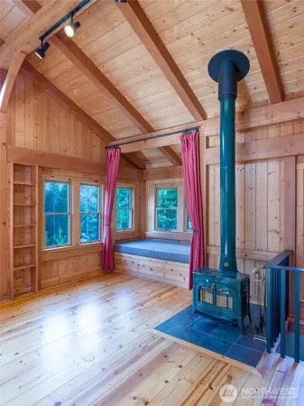a view of a porch with wooden floor and furniture