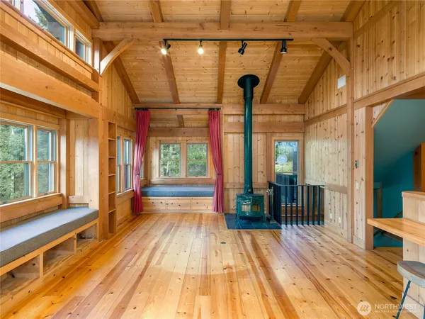 a view of a room with wooden floor and a window