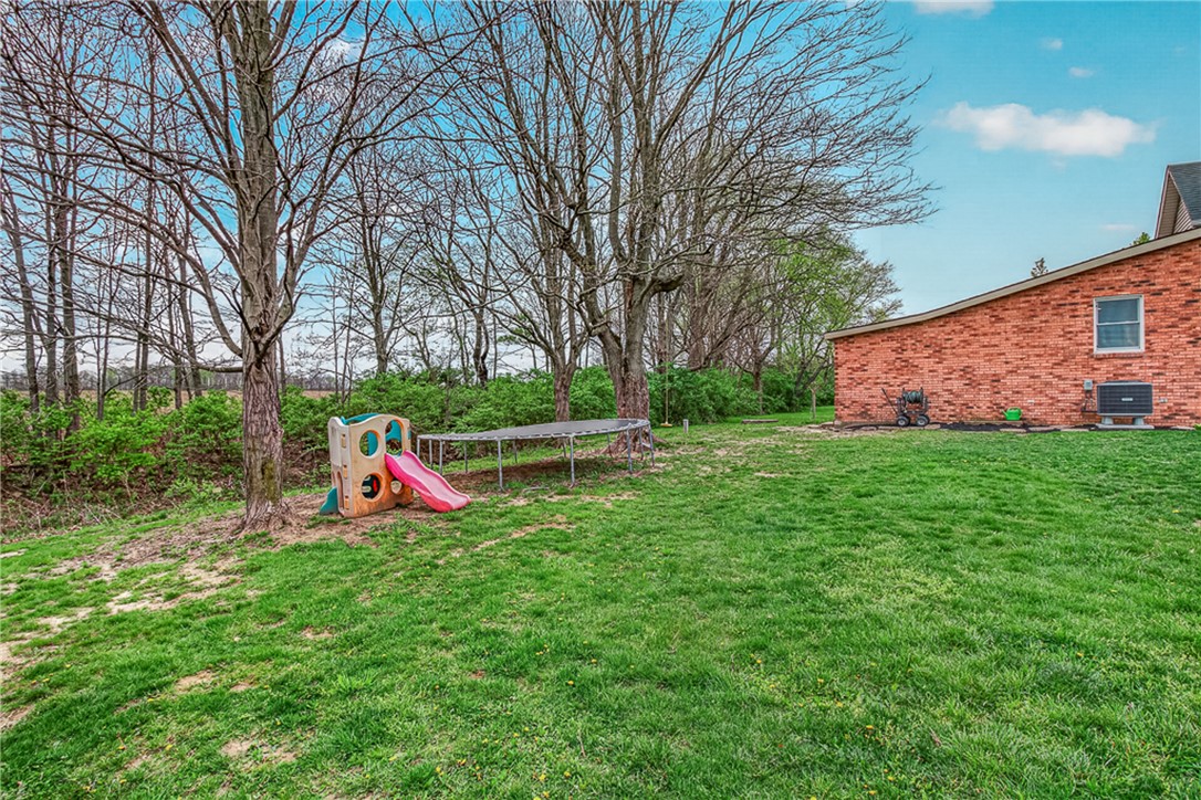 8700 Quaker Trace Road Camden, OH 45311 - Photo 23 of 34 The expansive backyard offers ample green space for outdoor activities and future enhancements.