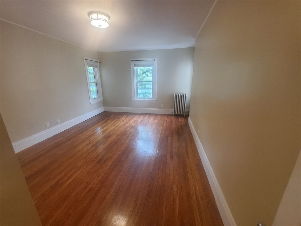 45 Intervale Street, Unit 2 Boston, MA 02121 - Photo 10 of 17 an empty room with wooden floor and windows