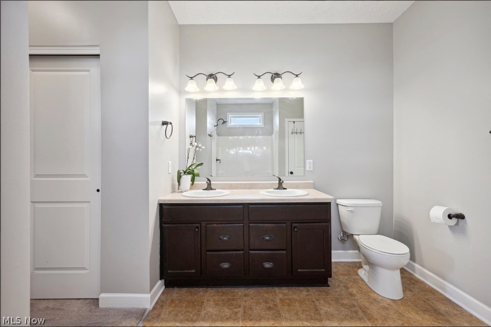405 East Luchsinger Road Port Clinton, OH 43452 - Photo 19 of 40 Bathroom with toilet, tile floors, and dual vanity