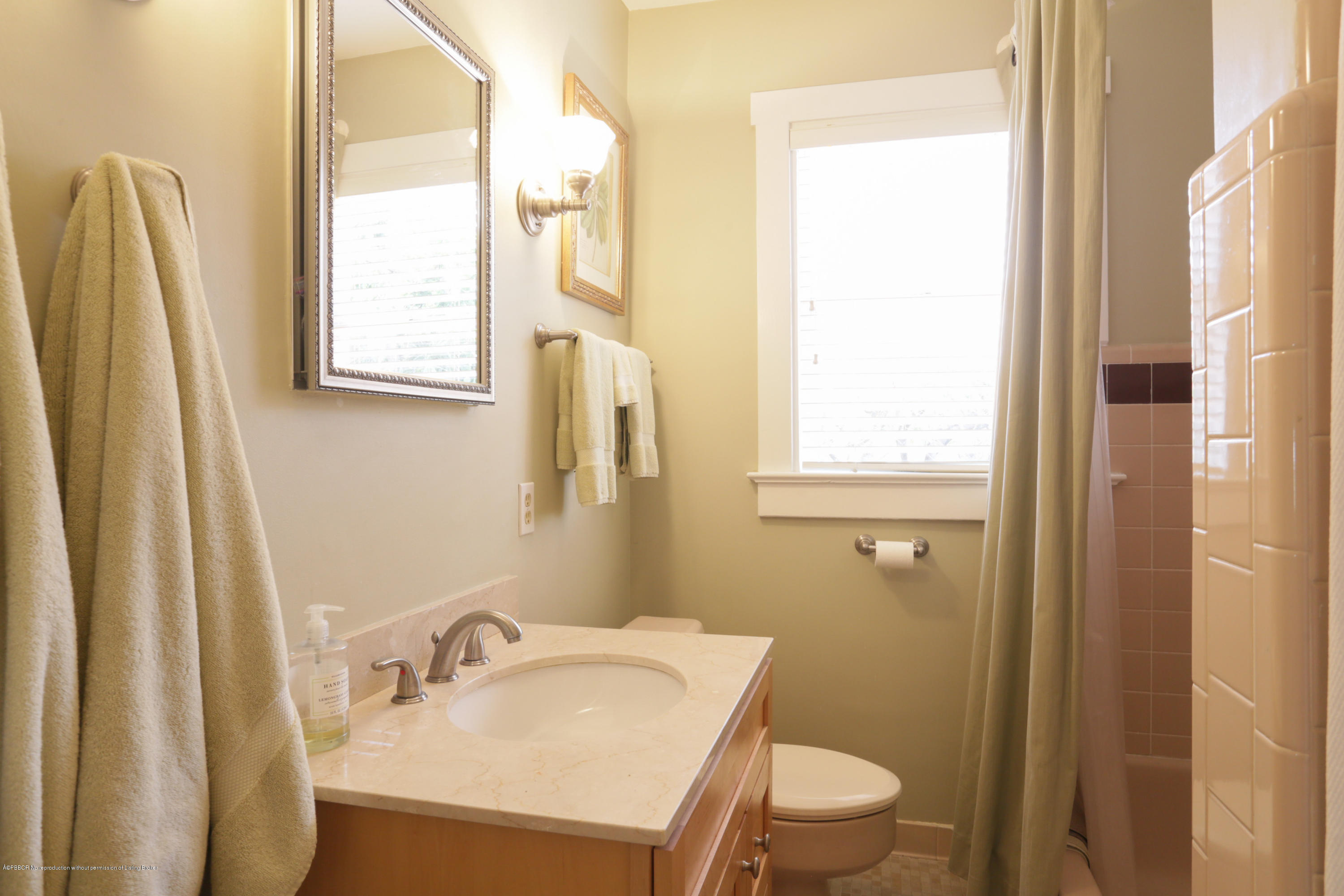 194 Almeria Road West Palm Beach, FL 33405 - Photo 18 of 25 a bathroom with a sink a toilet and a mirror