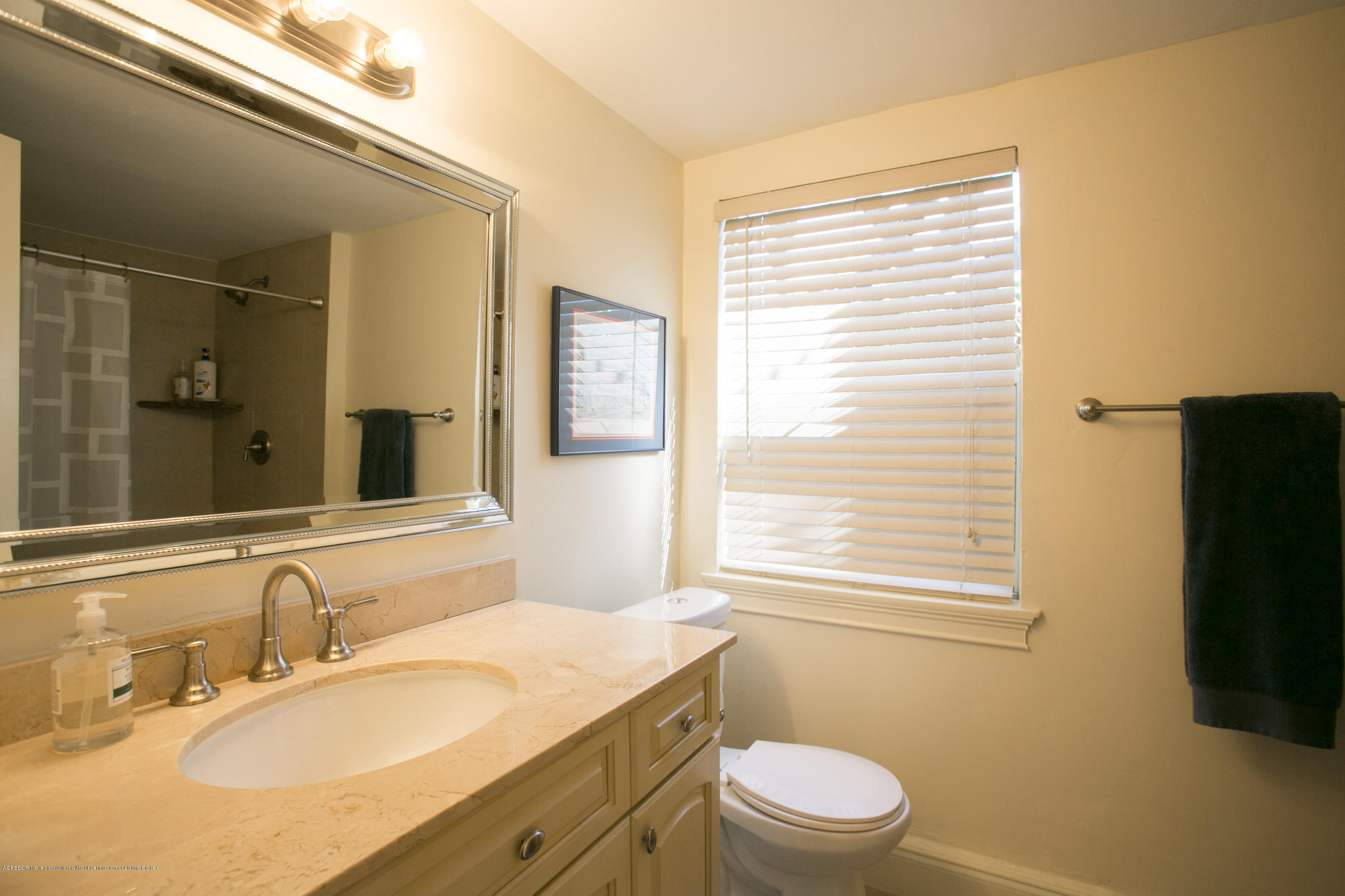 194 Almeria Road West Palm Beach, FL 33405 - Photo 19 of 25 a bathroom with a granite countertop sink toilet a mirror and a window