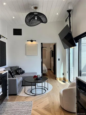 a living room with furniture and a chandelier