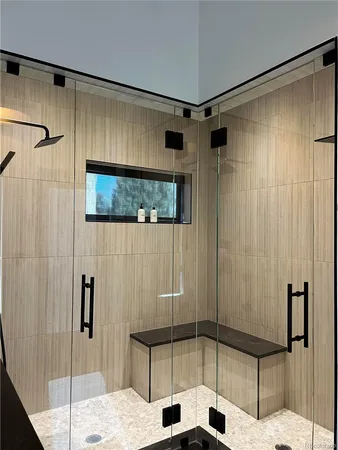 a bathroom with a shower and a sink