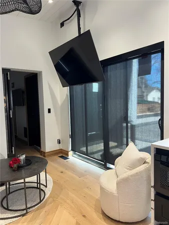 a living room with a couch and chandelier