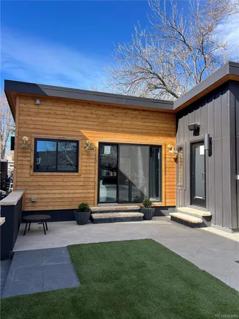 a backyard of a house with table and chairs