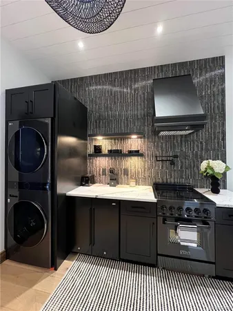 a kitchen with a sink a stove and cabinets