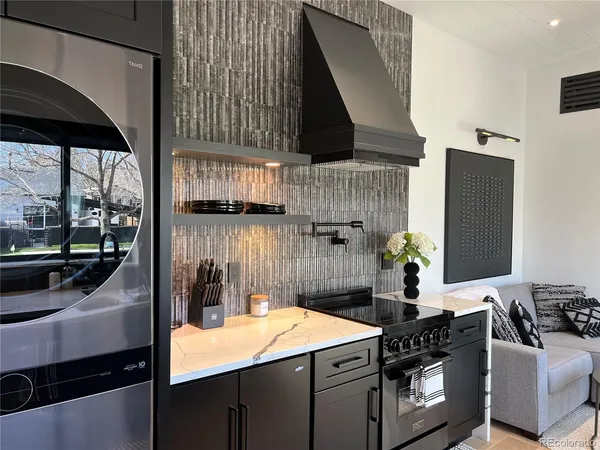 a kitchen that has a sink and a stove