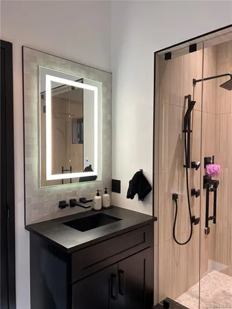 a bathroom with a sink vanity and a mirror