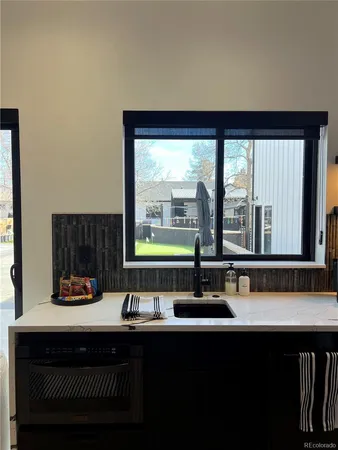 a bathroom with a sink and a large window