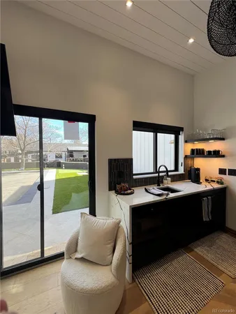 a view of a living room and kitchen with a large window