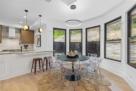 a dining room with furniture and wooden floor