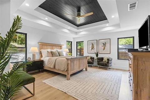 a spacious bedroom with a bed couch and a window