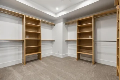 a view of walk in closet with empty racks