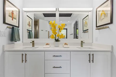 a bathroom with a double vanity sink and mirror