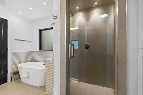 a bathroom with a bathtub and shower