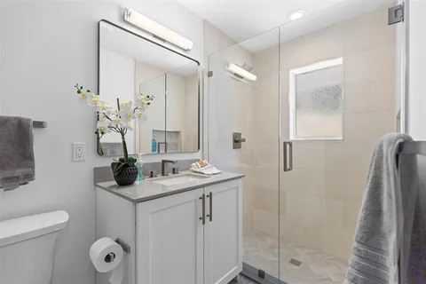 a bathroom with a toilet sink and mirror