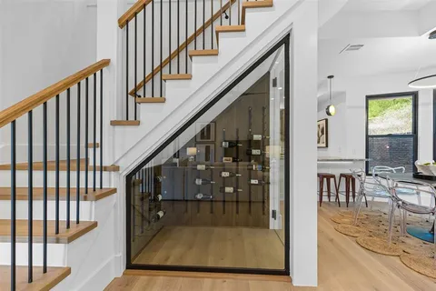 a view of staircase with lots of frames on wall and a black white checkered floor