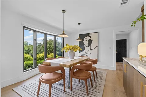 a view of a dining room with furniture window and outside view