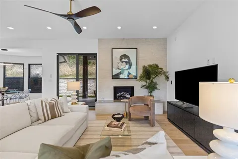 a living room with furniture a fireplace and a flat screen tv