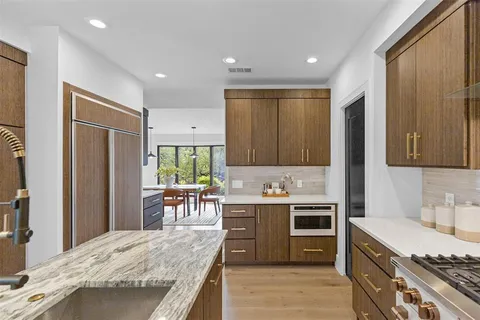 a kitchen with a sink stove and refrigerator