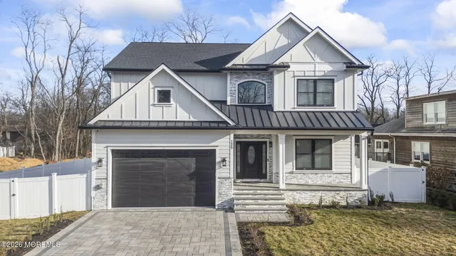 a view of a white house with large windows