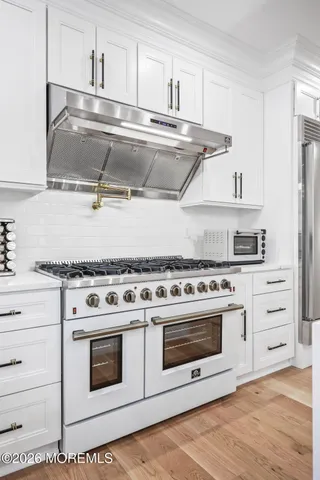 a bathroom with a granite countertop sink a mirror and shower
