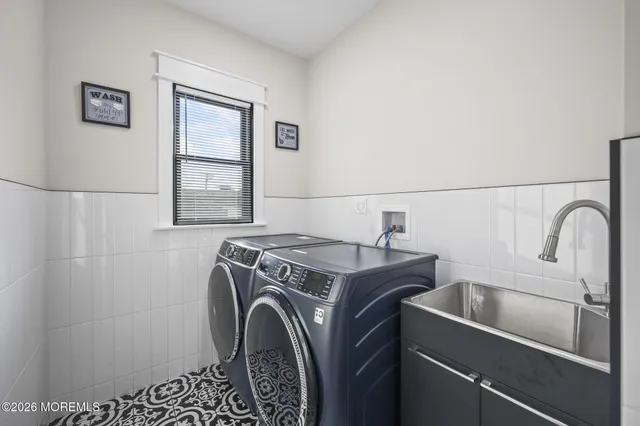 a view of a white house with a big yard and large trees