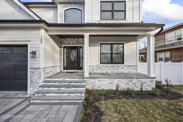 a view of entryway with wooden floor and stairs