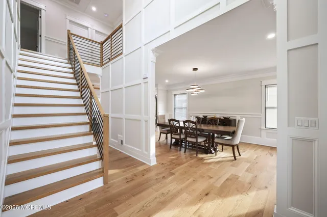 a view of a hallway with wooden floor and entryway