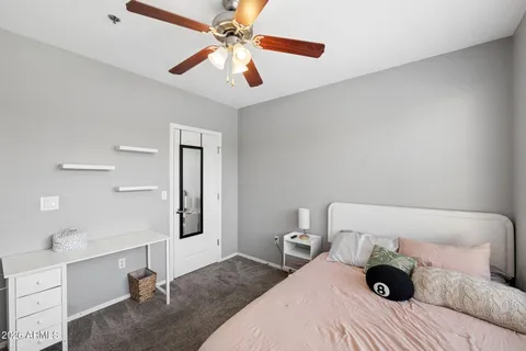 a bedroom with a bed and a large window