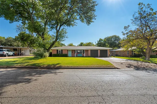 a view of swimming pool in front of house
