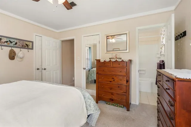 a bedroom with a dresser and a mirror