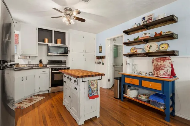 a kitchen with stainless steel appliances granite countertop a stove and a microwave