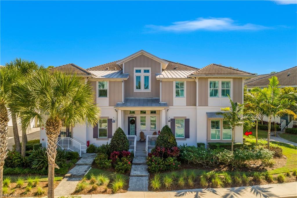 6552 Dominica Drive, Unit 101 Naples, FL 34113 - Photo 1 of 50 a front view of a house with a yard